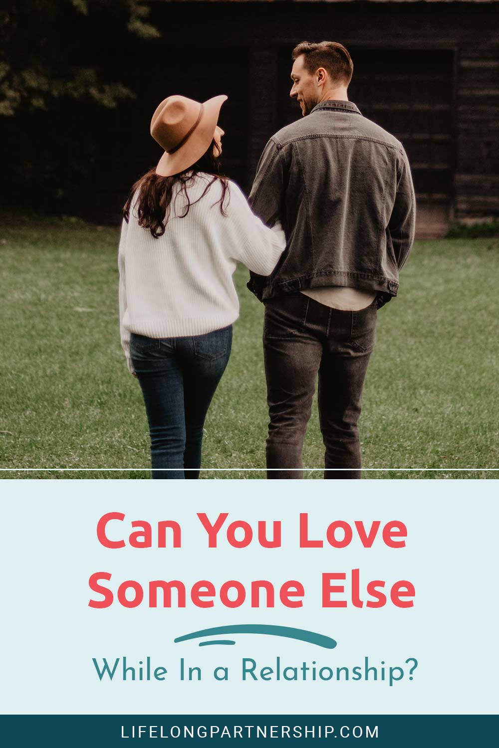 Couple holding their hands and smiling at each other - Can You Love Someone Else While In a Relationship?